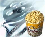 A container of popcorn and a movie reel.
