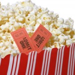 red and white box of popcorn and movie tickets