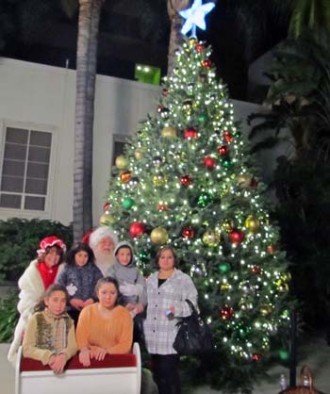 Photo: FLLewis/Media City G -- A group of visitors to the Mayor's Annual Christmas Tree Lighting Ceremony took a photo with Santa and Mrs. Claus after the festivities Burbank December 7, 2013