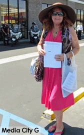 Photo: FLLewis/Media City G- Marsha Hunt of Los Angeles passed out discount coupons and gift certificates for other retailers at Hobby Lobby protest in Burbank July 7, 2014