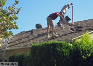 Photo: FLLewis/Media City G -- Two guys tearing off a roof on South Mariposa Street in Burbank July 24, 2014