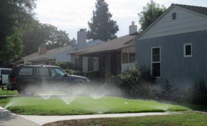 Photo: FLLewis/Media City G -- Sprinklers watered a yard in the 1400 block of West Clark Avenue in Burbank July 30, 2014