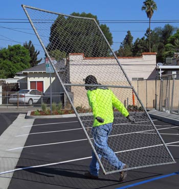 Photo: FLLewis / Media City G -- Worker removed fence surrounding the new parking lot in Magnolia Park Burbank September 13, 2014