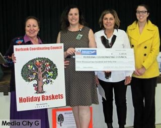 Photo: FLLewis / Media City G -- Burbank Coordinating Council accepts donations of gifts and check for $3,249 from Bob Hope Airport Holiday Charity Committee in Burbank December 1, 2014 . (l-r) Janet Diel, president Burbank Coordinating Council, Sherri Himelstein, Lucy Burghdorf, Rachael Warecki