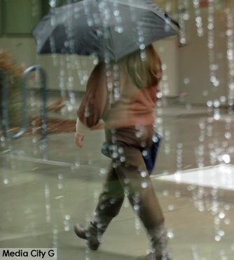 Photo: FLLewis / Media City G -- A pedestrian caught in a downpour during first big storm of the season in Burbank December 2, 2014