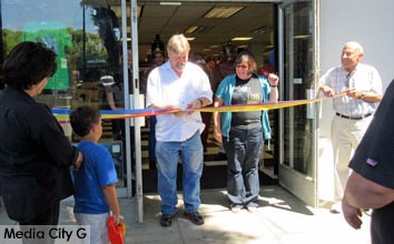 Photo: FLLewis/ Media City G -- Owner, Larry Ross cuts the ribbon at grand opening of Blast from the Past, while co-owner/wife Kathy Ross and store customers watch Saturday July 25, 2015