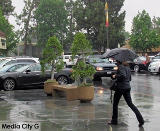 Photo: FLLewis / Media City G -- Woman under umbrella in the rain scurried across the parking lot of the Lakeside Shopping Center in the 300 block of North Pass Avenue Burbank April 8, 2016