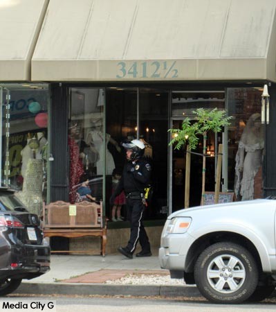 Photo: FLLewis / Media City G -- Cop walks out of Antiques on Magnolia, 3412 1/2 West Magnolia Blvd, yesterday afternoon. Burbank May 22, 2018