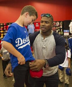 Photo: Jon SooHoo/LA Dodgers -- Yasiel Puig helped a young boy get the right fit for his Dodger shirt at the Sports Authority in Burbank June 14, 2014