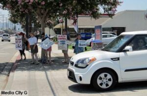 Photo: FLLewis/ Media City G -- Demonstrators against U.S. Supreme Court ruling gathered at parking lot entrance to Hobby Lobby in Burbank July 5, 2014