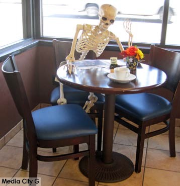 Photo: FLLewis / Media City G -- A creepy skeleton occupied a corner table at Martino's Bakery in Burbank October 30, 2014