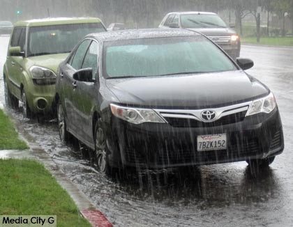 Photo: FLLewis / Media City G -- Heavy rain flowed into street gutters on West Olive Avenue in Burbank December 12, 2014