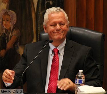 Photo: Greg Reyna / Media City G -- A very pleased Will Rogers takes a seat for the first time on the city council in Burbank May 1, 2015